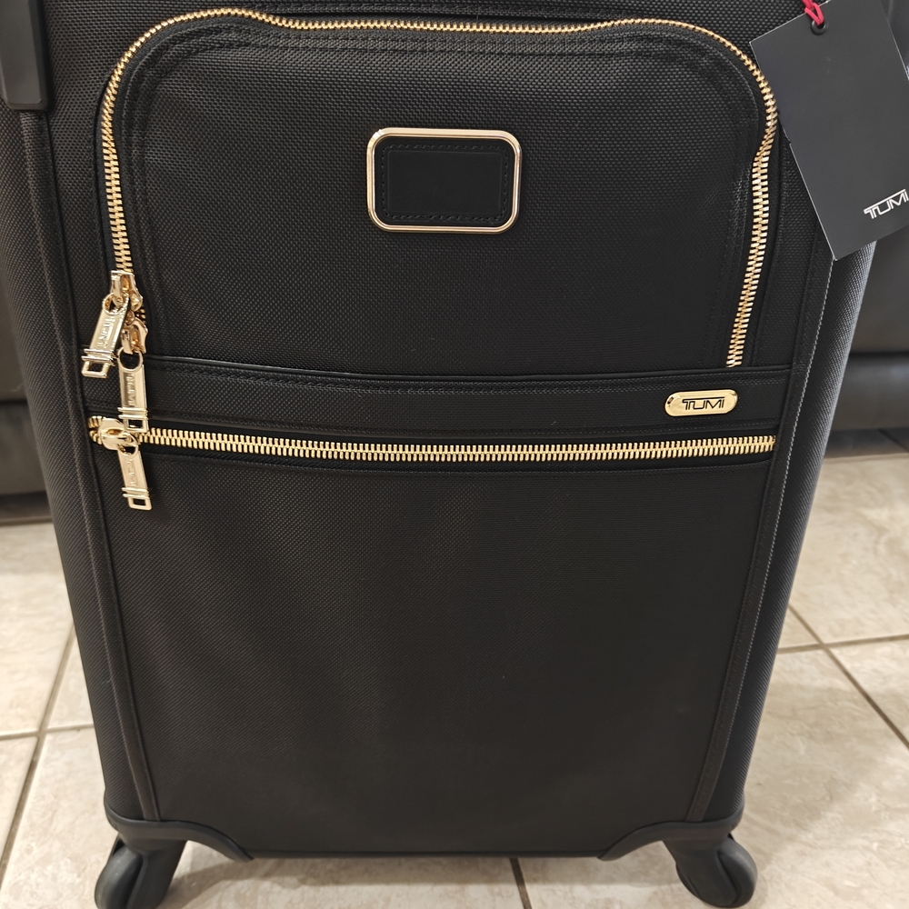 TUMI Black Travel Bag with Gold Accents